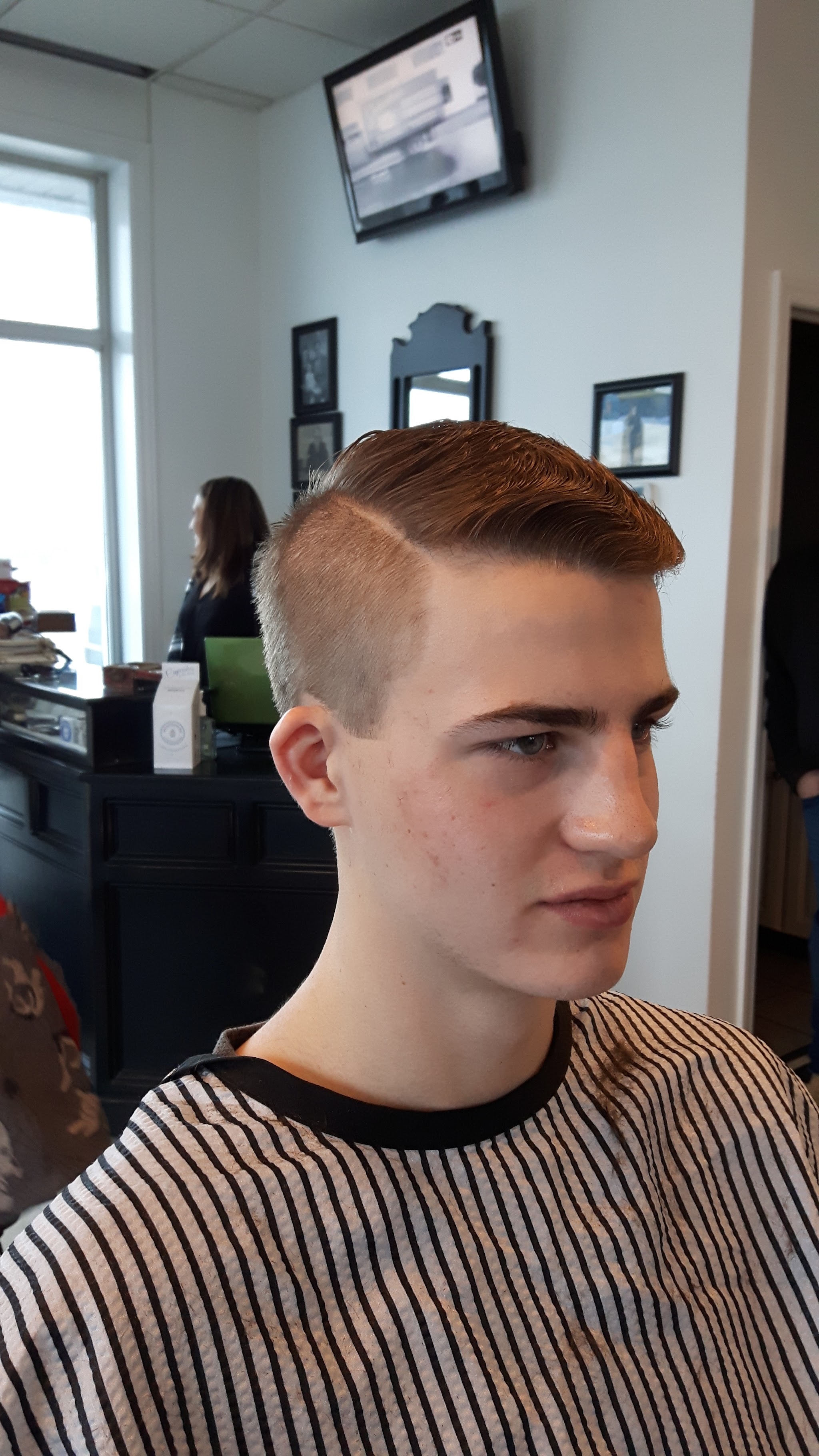 Sharp hard-part fade haircut at Back To Barbering